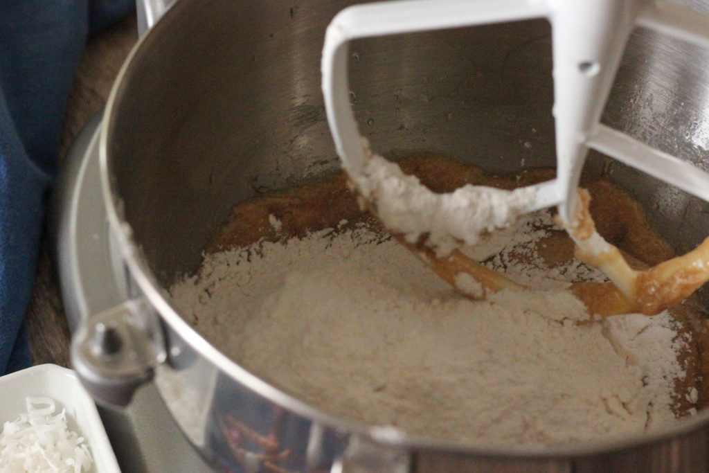 Image of cookie dough batter being mixed in a stand mixer. 