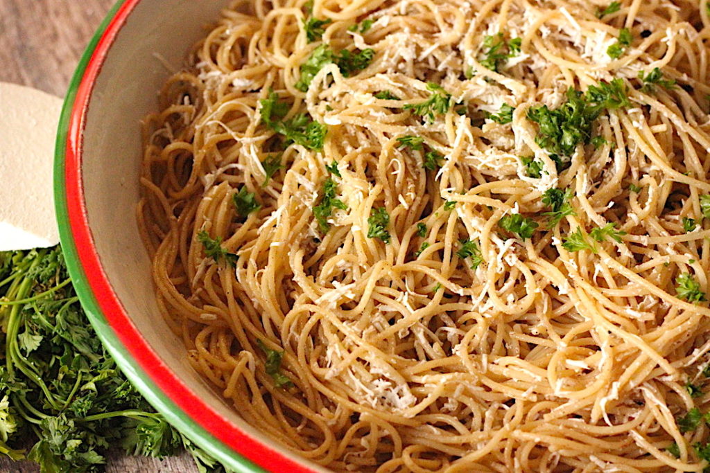 Browned butter spaghetti topped with grated mizithra cheese and parsley