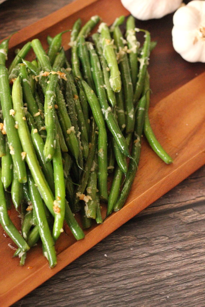 Garlic Parmesan Green Beans cooked on a wooden platter