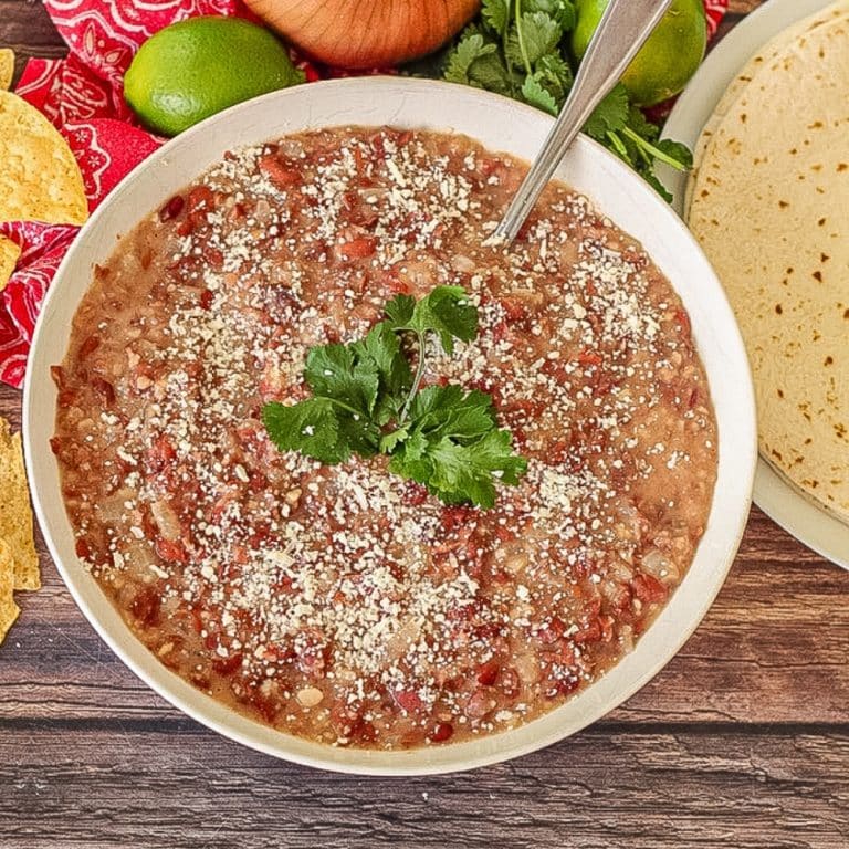 homemade refried beans in a white serving bowl