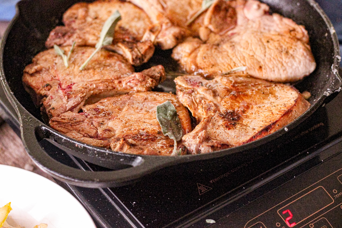 cooking pork chops in a cast iron pan