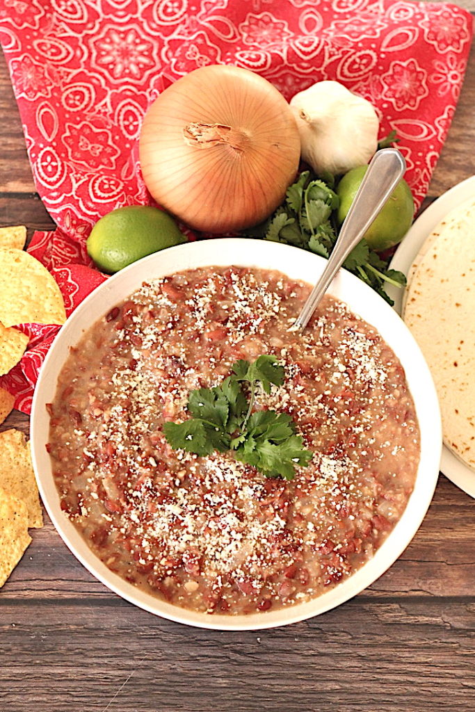 simple refried beans topped with cilantro and queso cotijo