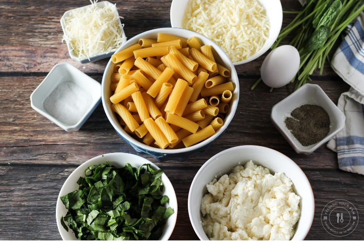 ingredients for spinach ricotta pasta. Rigatoni noodles, spinach, ricotta, mozzarella, parmesan, salt and pepper