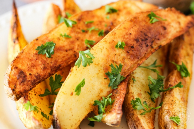 golden air fried potato wedges topped with parsley
