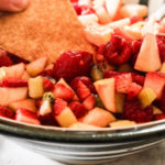 cinnamon chip dipping into fruit salsa