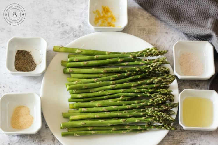 asparagus surrounded by spiced in white bowls