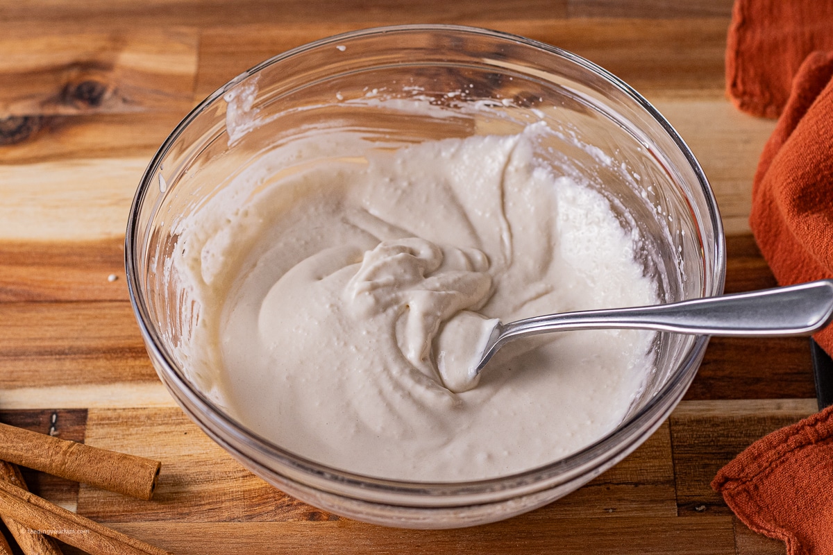 cream cheese frosting for cinnamon biscuits baked in a cast iron skillet