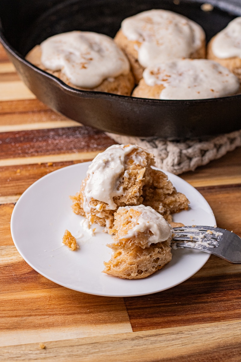 These Cinnamon Biscuits with Cream Cheese Frosting are golden, flaky biscuits with a cinnamon sugar twist, like having a cinnamon roll in under 20 minutes!! The Cream Cheese Frosting is creamy and delicious and just takes these biscuits over the top!! Baked in a cast iron skillet gives them a crispy bottom with a soft, fluffy center.