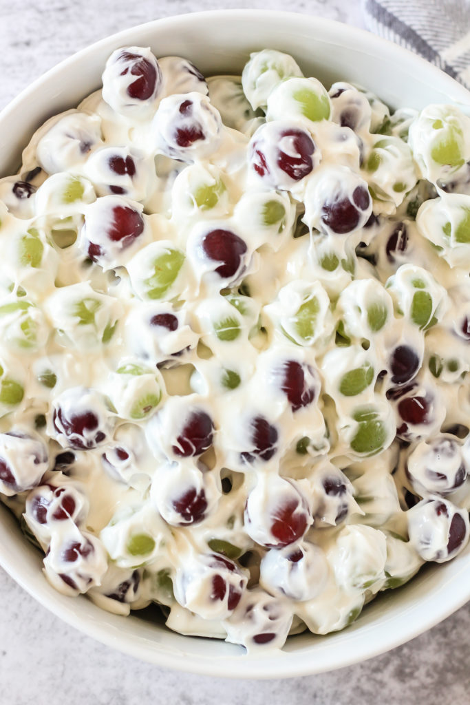 red and green grapes covered in a creamy white dressing