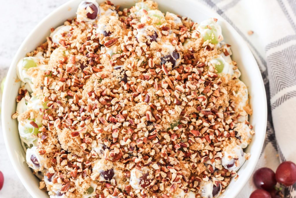 grape salad topped with pecans and brown sugar