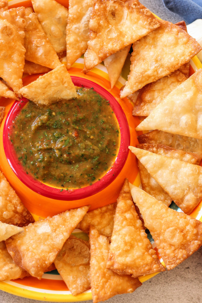 dish with salsa in the center surrounded by chips.