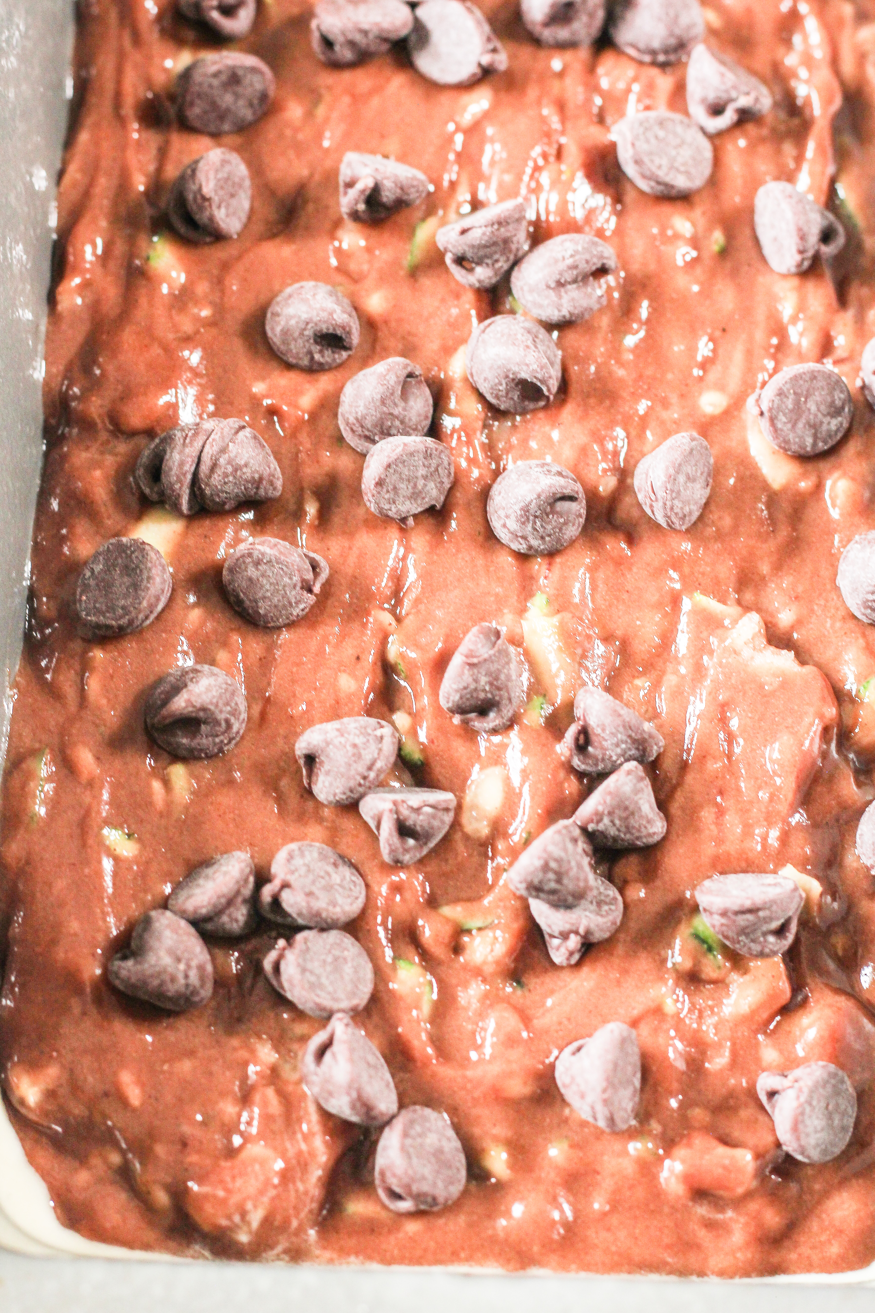 chocolate zucchini bread batter in a loaf pan