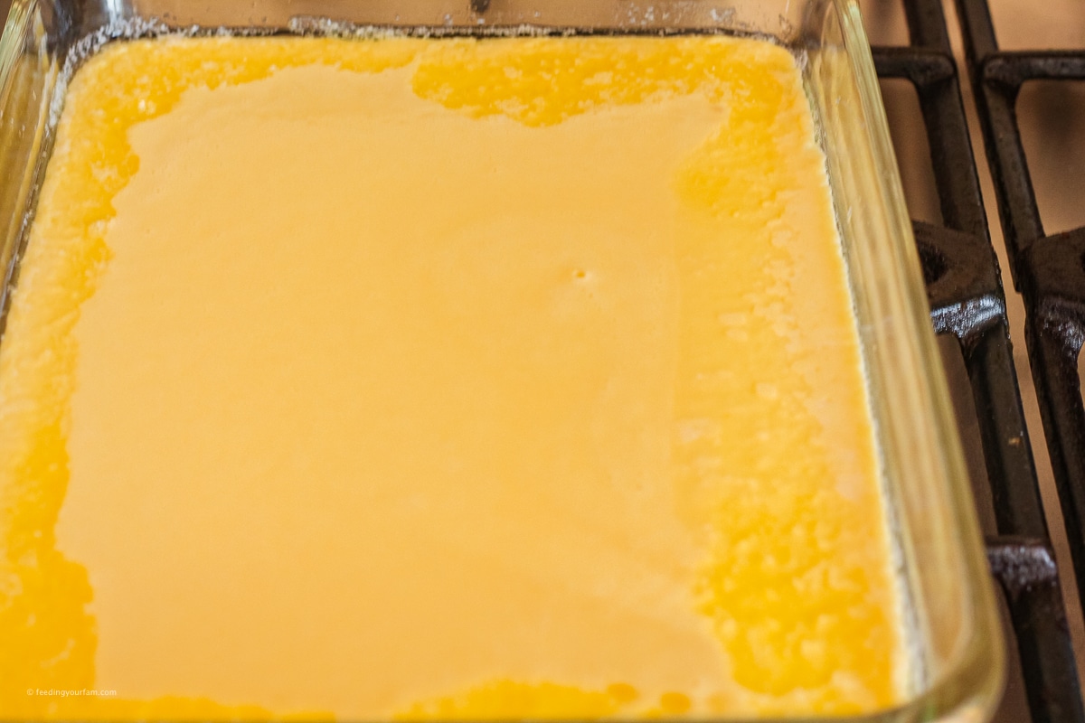 puffy pancake batter poured into a glass baking dish