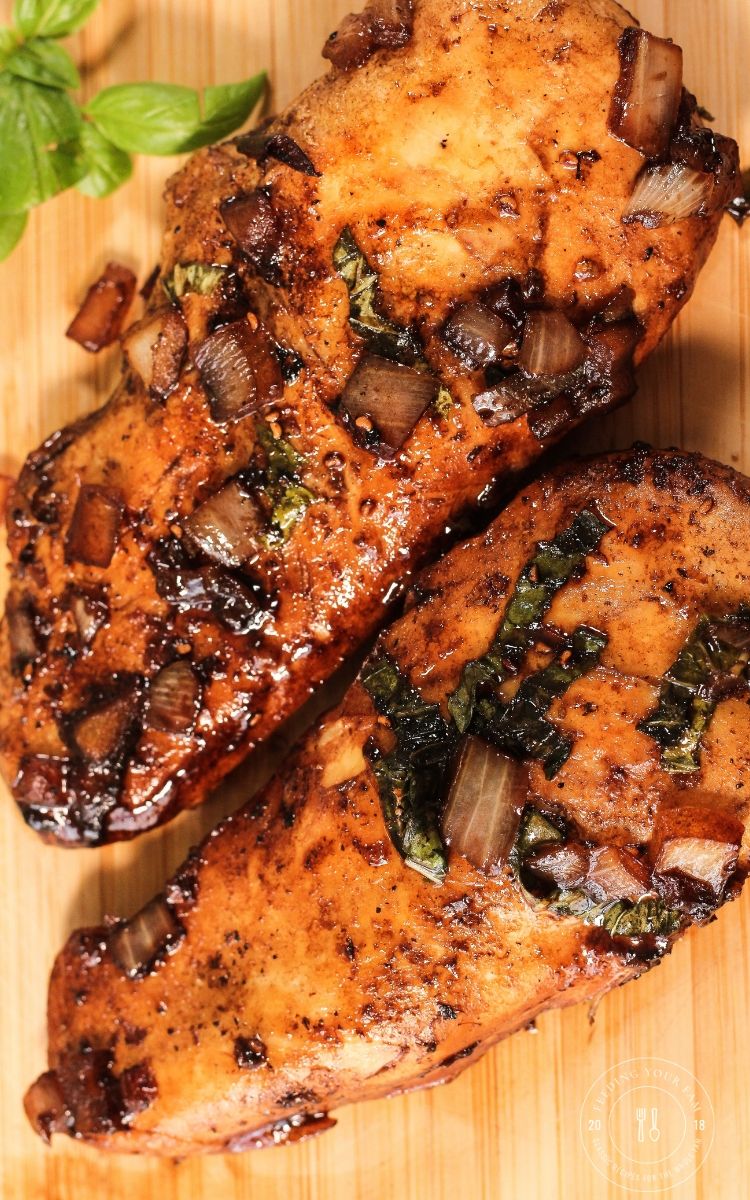cooked chicken on a wooden cutting board