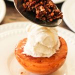 topping caramelized peaches with toasted pecans