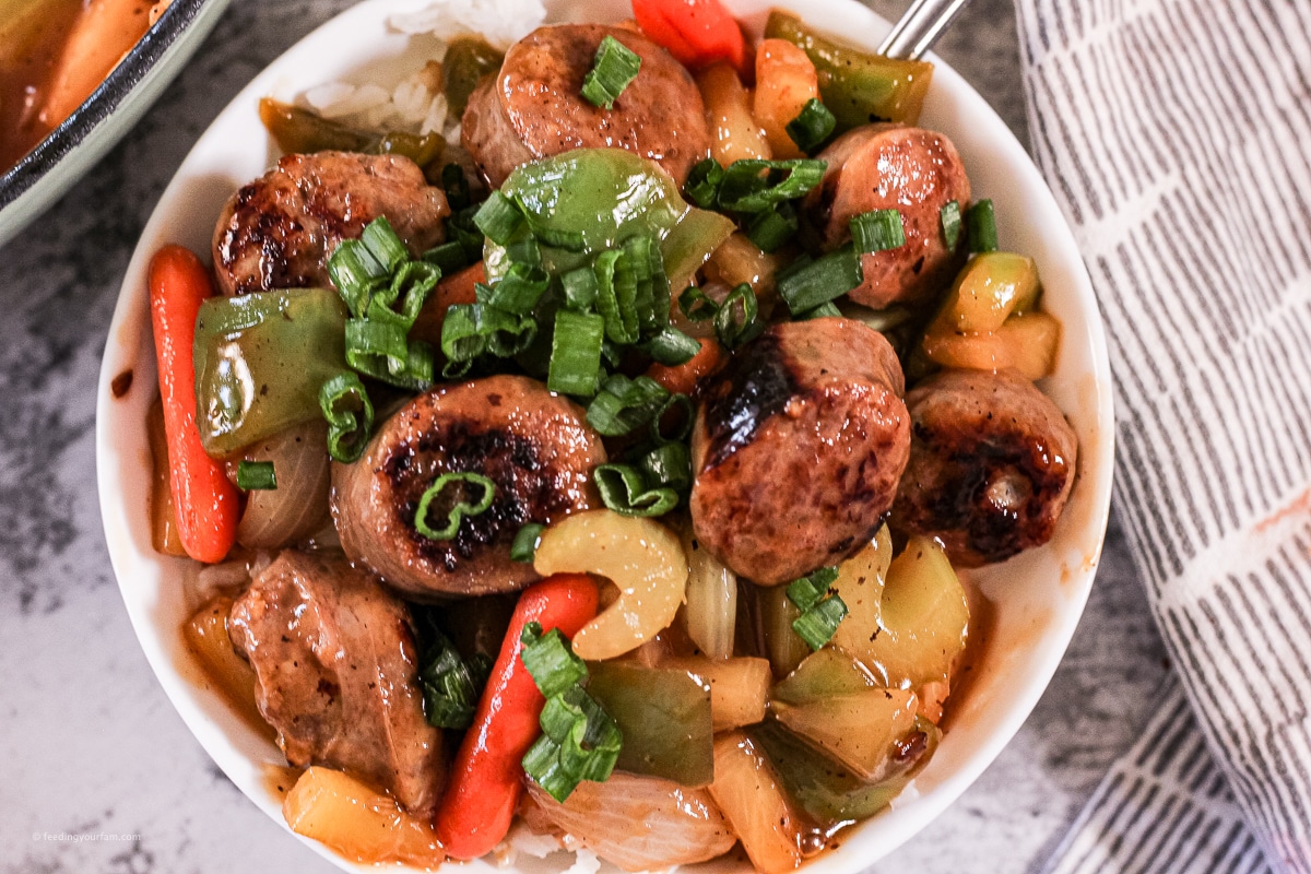sliced italian sausages cooked with vegetables in a sweet and sour sauce