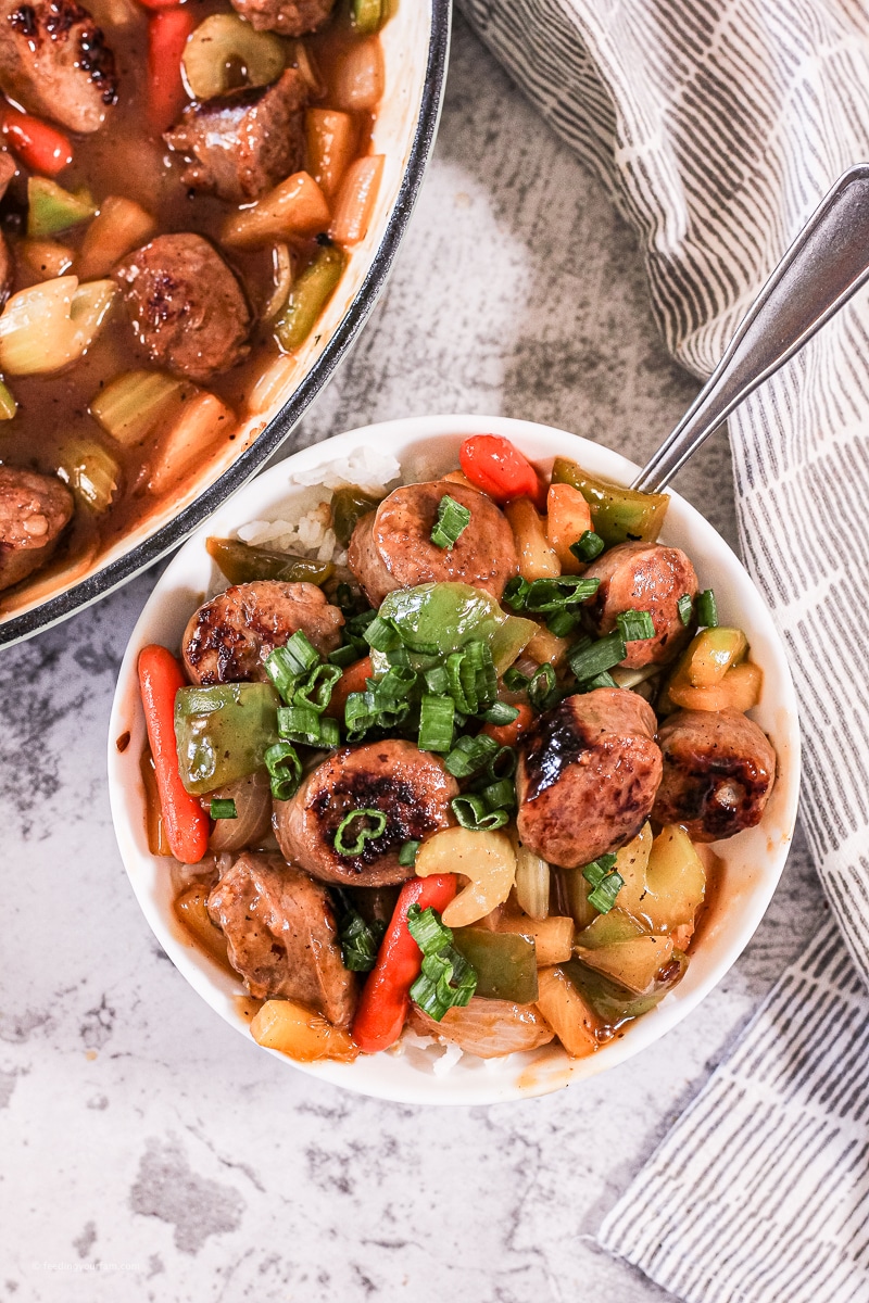 sweet and sour sausages with green peppers, onions, carrots, and pineapples