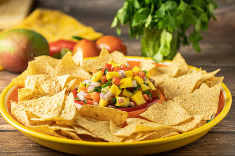 mango salsa on a platter with chips