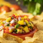 mango salsa surrounded by corn chips