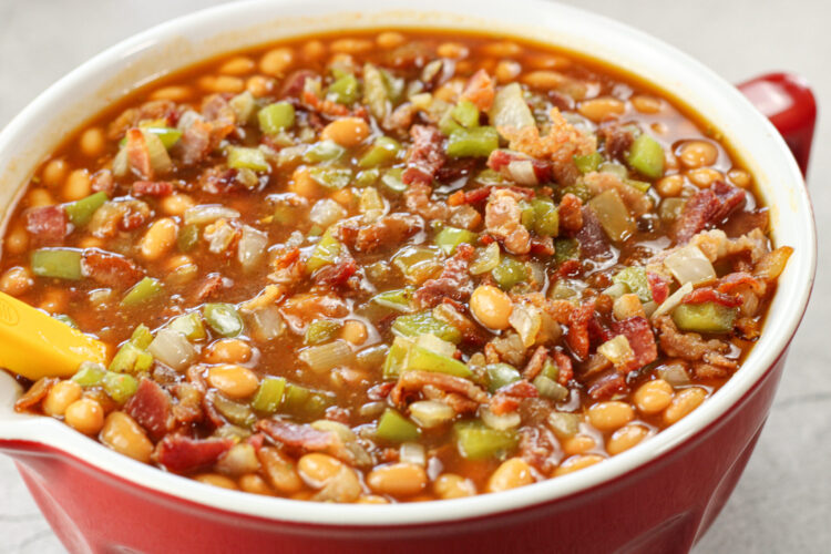 mixed baked bean mixture in a red mixing bowl