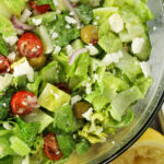green salad with tomatoes, feta cheese, red onions, cucumbers and green onions