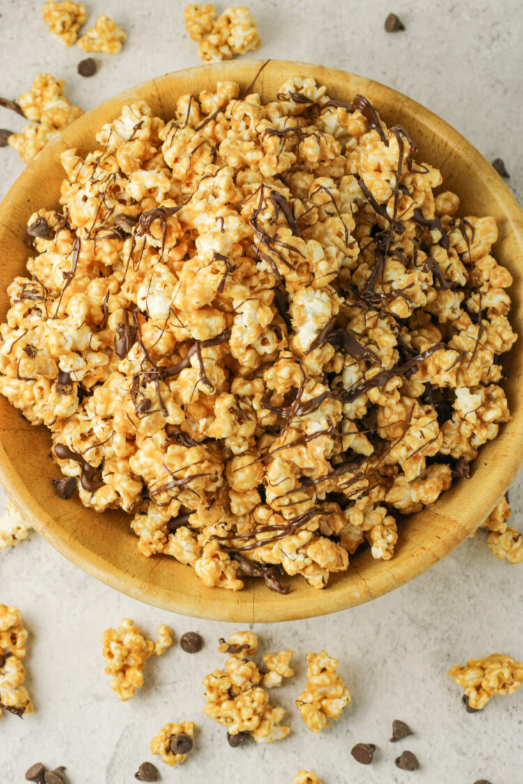 bowl of peanut butter popcorn with chocolate drizzle