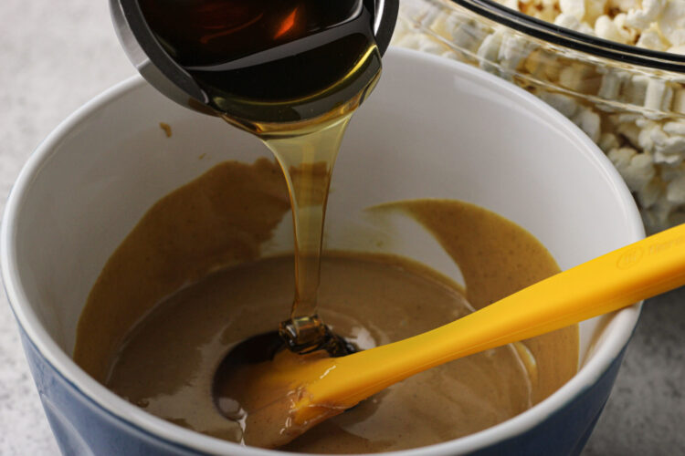 pouring honey into softened peanut butter