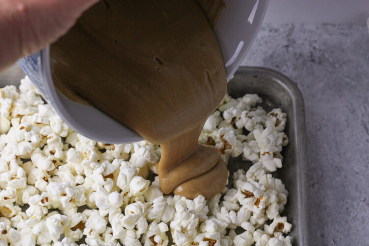 pouring peanut butter over popcorn