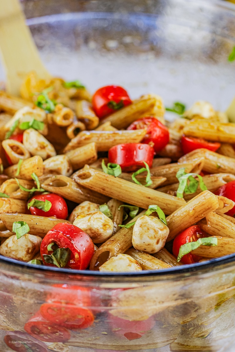 Tomato Basil Pasta Salad is a simple side dish with penne pasta, tomatoes, basil, fresh mozzarella with a delicious balsamic vinegar dressing. This pasta salad is perfect to serve for a simple dinner or delicious side at a potluck party.