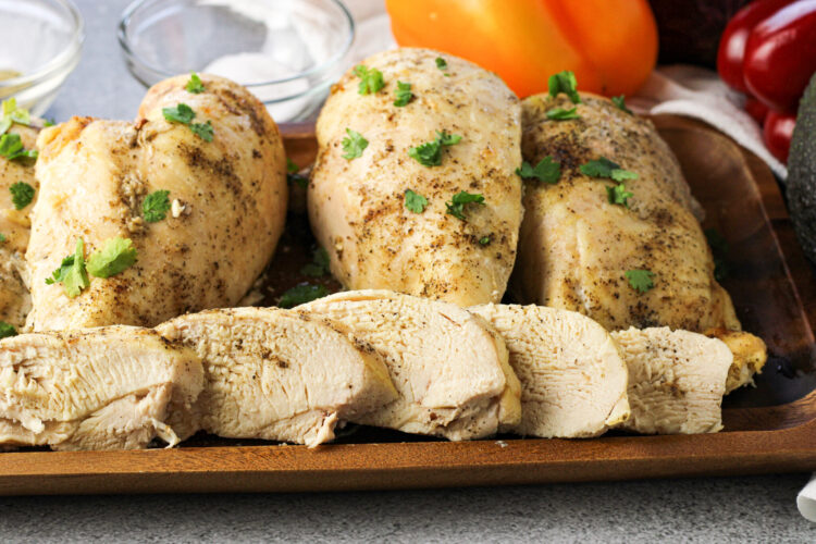 sliced chicken breasts with whole breasts behind