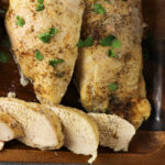 chicken breasts on a wooden platter