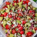 salad made with tomatoes, cucumbers, red onions, feta cheese and balsamic dressing.