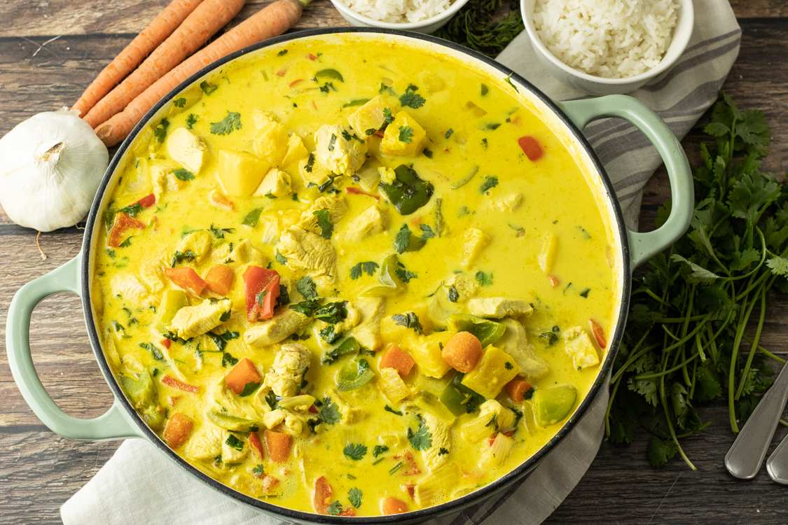 large pot of yellow curry with pineapples