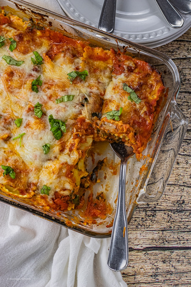 Ravioli Lasagna is a super easy way to make a quick lasagna like dish in just 30 minutes. This ravioli lasagna recipe is layers of sauce, cheesy ravioli pasta, spinach and of course cheese.