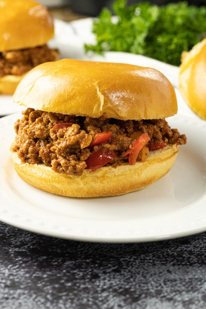 sloppy joe sandwich on a white plate