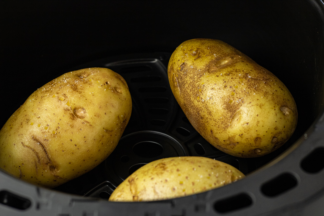 baking potatoes in the basket of the air fryer