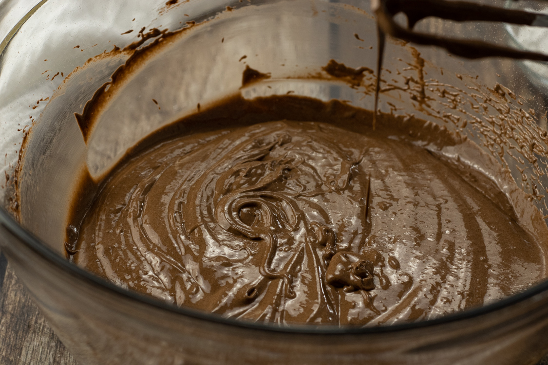 chocolate cake batter in a glass mixing bowl