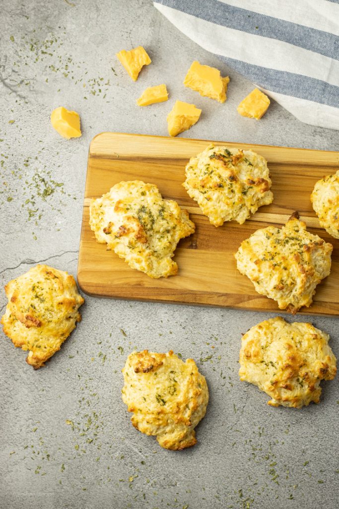 cheddar bay biscuits on a wooden platter