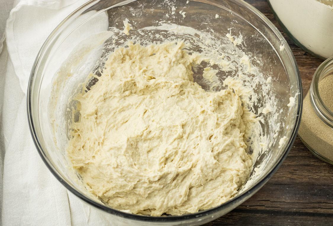 bread dough in a glass mixing bowl