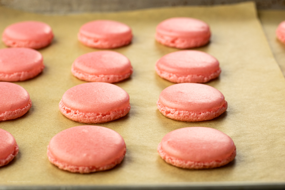 pink cookies on a baking sheet