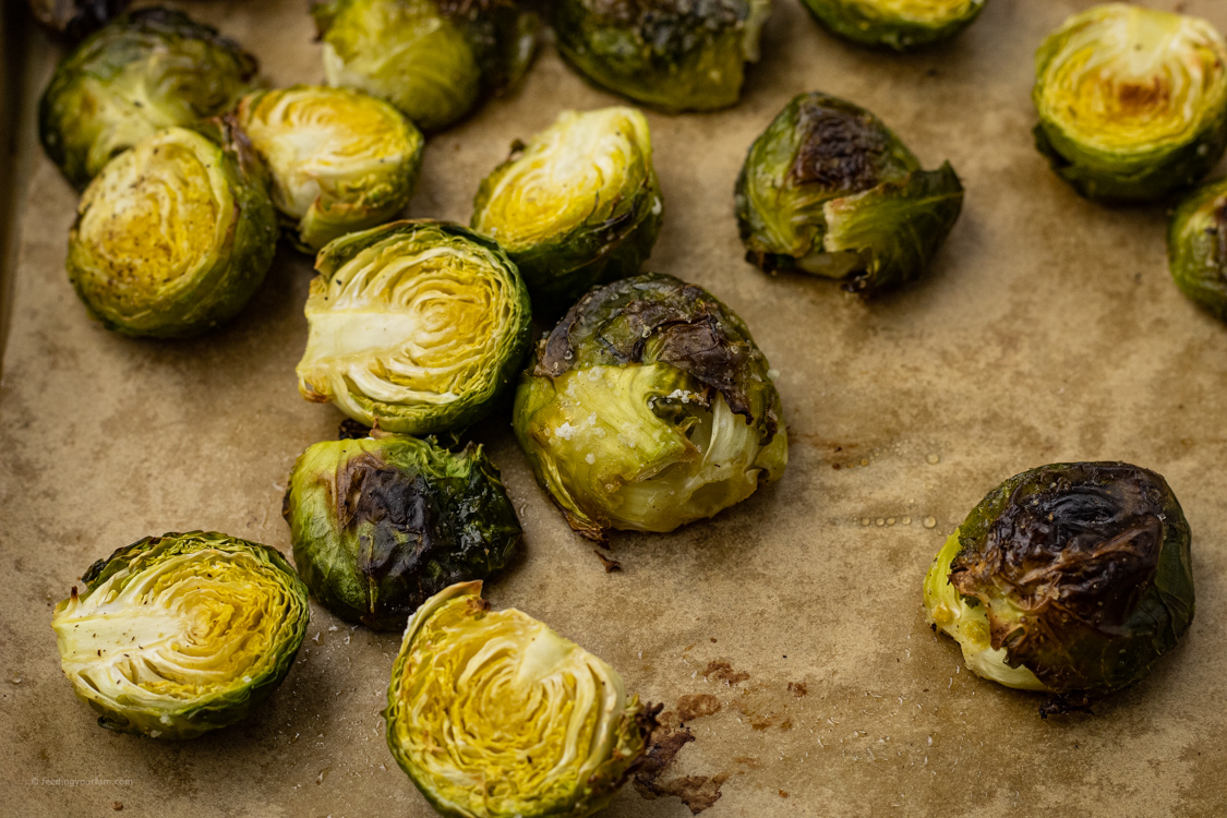 baked brussel sprouts on a baking sheet