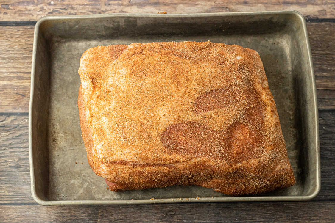 seasoned pork roast in a roasting pan