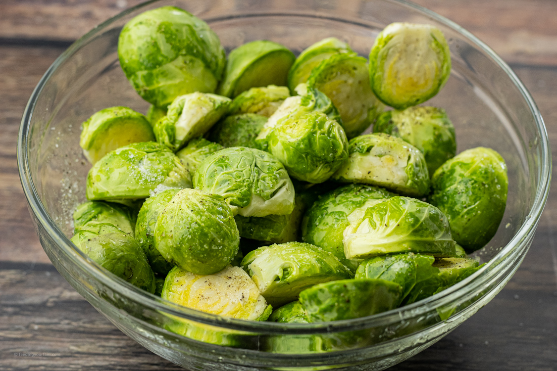 brussel sprouts sliced in half and seasoned with olive oil, salt and pepper