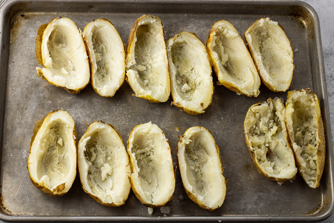 baked potatoes sliced in half with the inside removed