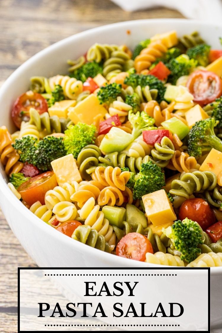 big bowl of tri color pasta with cheese and veggies
