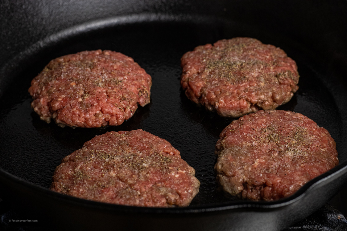 cooking burgers in a cast iron skillet