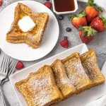 pile of french toast on white plates