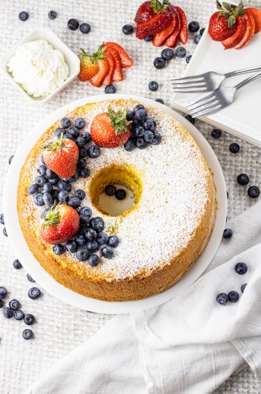chiffon cake topped with powdered sugar, blueberries and strawberries