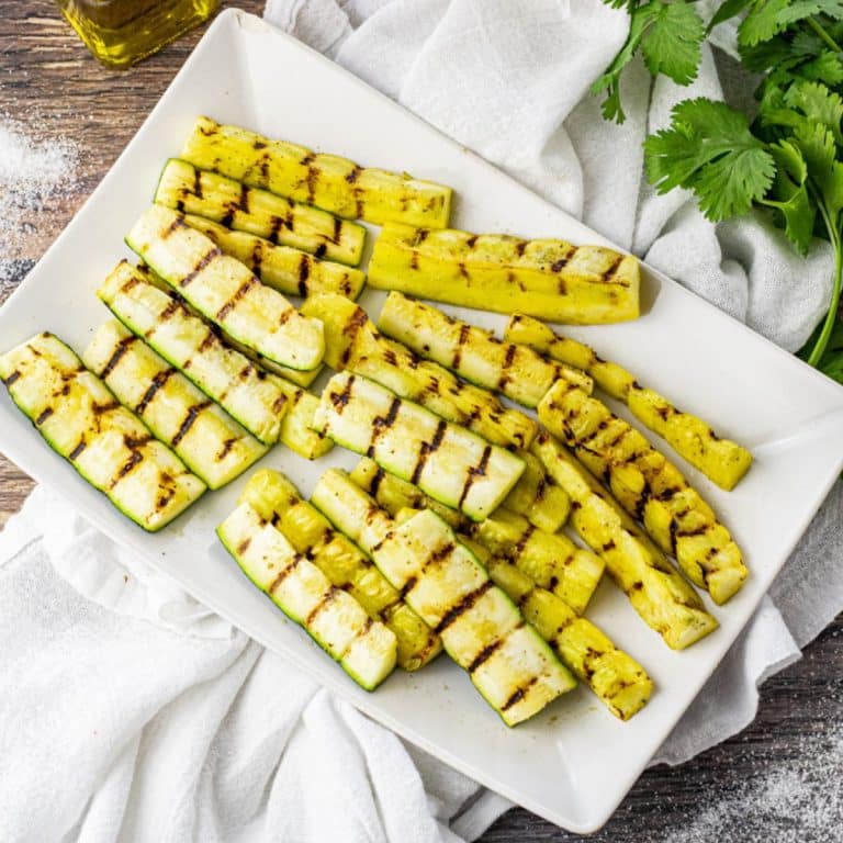 grilled zucchini and yellow squash on a white platter