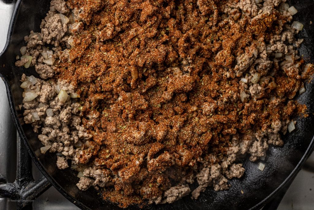 seasoned, cooked ground beef in a cast iron pan